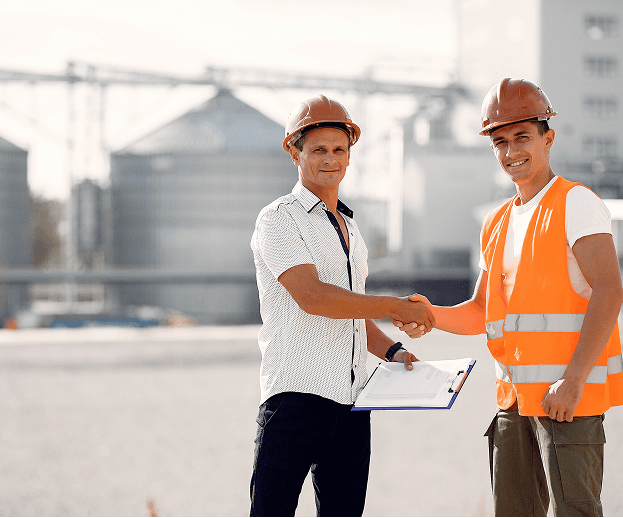 Two construction workers shaking hands
